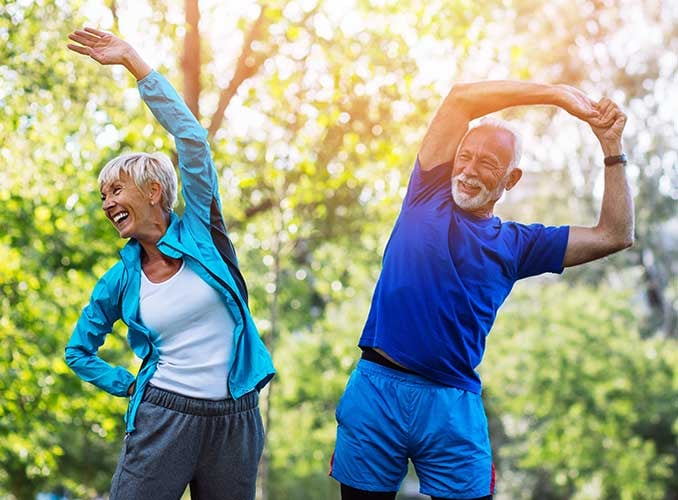 elderly couple stretching back and neck